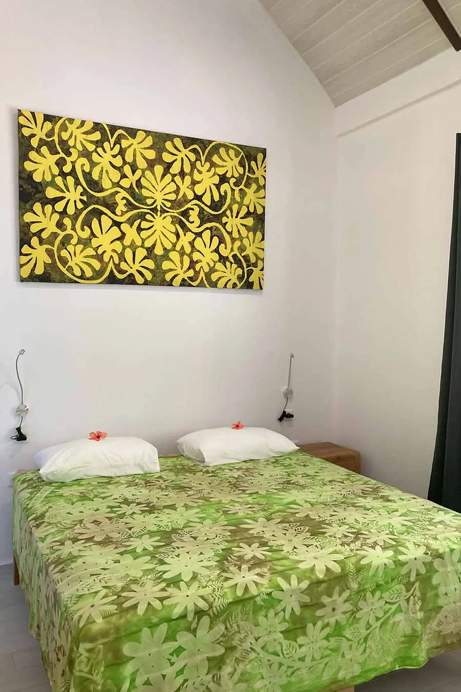 Double bed with artwork on the wall in our vacation home in Bora Bora