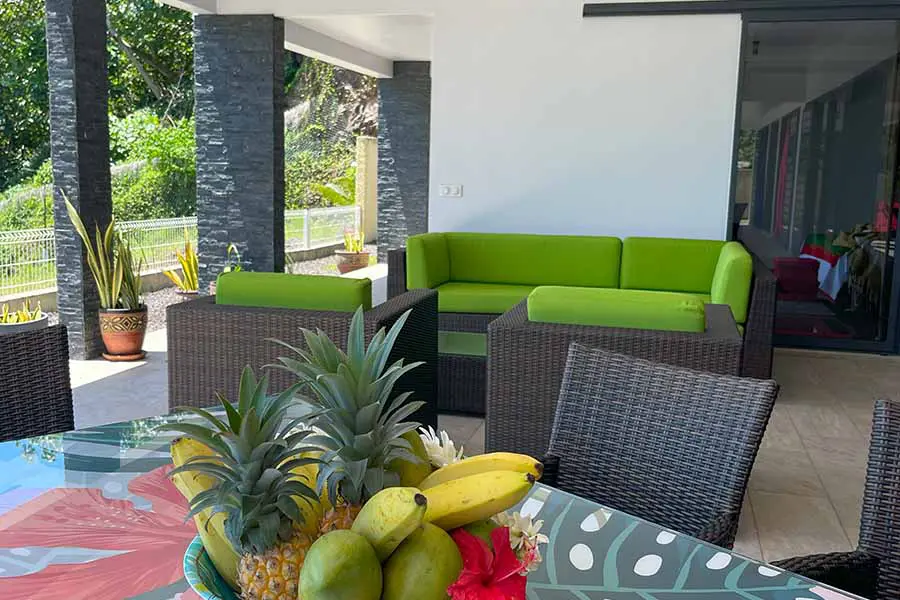 Outdoor lounge area on terrace with dining table and lagoon view in Bora Bora